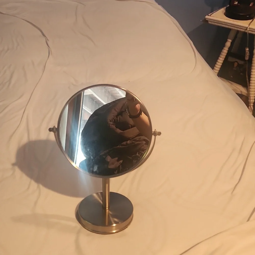 Double-sided vanity mirror, one side magnified. Silver frame